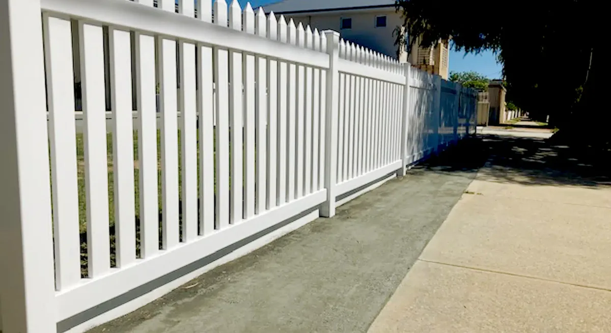 White PVC picket fencing along a Perth garden boundary